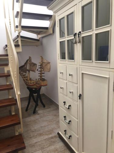 a room with a large white cabinet and a staircase at Baglio Mazzara in Custonaci