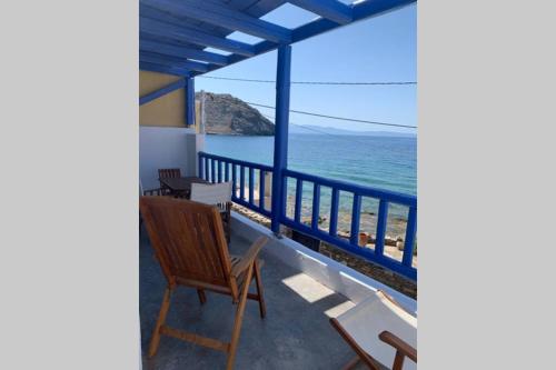 a balcony with a view of the ocean at ROMANTIC HOUSE 6 STEPS FROM THE SEA in Mochlos