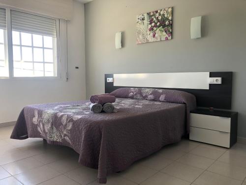 a bedroom with a bed with a teddy bear on it at Dukes Habitaciones in Bascuas