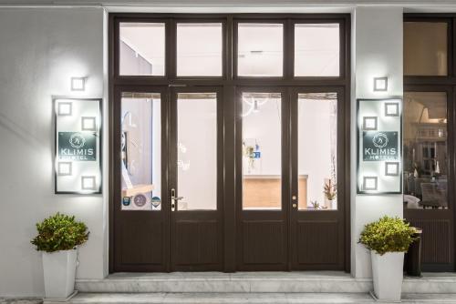 a door to a pharmacy with signs on it at Klimis Hotel in Spetses