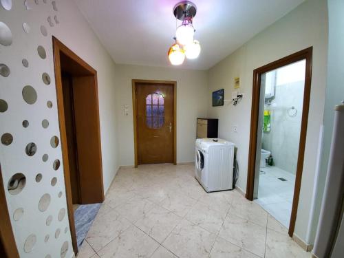a room with a bathroom with a shower and a refrigerator at Vila Emilio in Udënisht