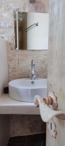 a bathroom with a sink and a mirror at Argento in Kimolos