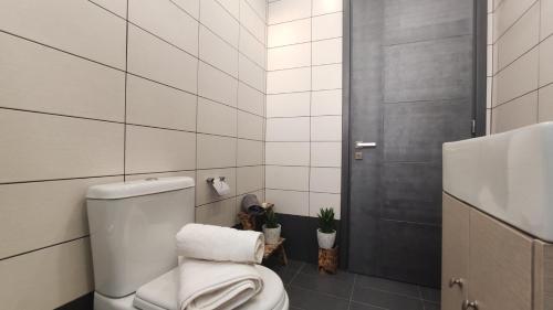 a white bathroom with a toilet and a shower at Villa Zante Avia in Plános