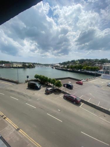 a view of a river with cars parked in a parking lot at Long Quay House in Kinsale