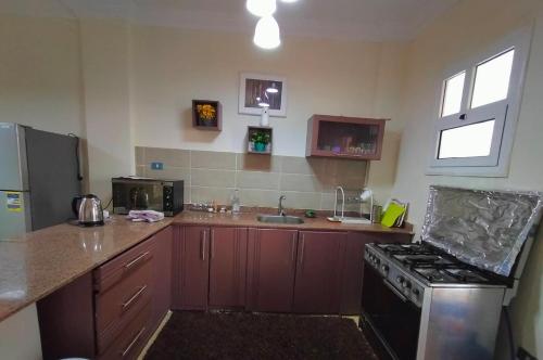a kitchen with a stove and a sink at Modern Chalet at Royal Beach resort in Marsa Matruh