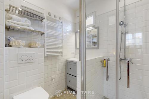 a white bathroom with a shower and a toilet at Villa Capriciosa - Five Stars Holiday House in Beaulieu-sur-Mer