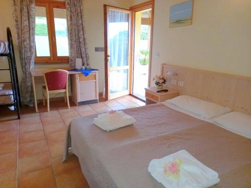 a bedroom with a bed with two towels on it at Tenuta il Giogo in Monterado