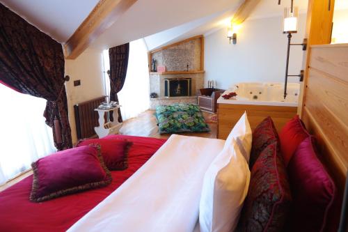 a bedroom with a large bed with red and purple pillows at Aşıklar Otel By Şükrü in Buyukada