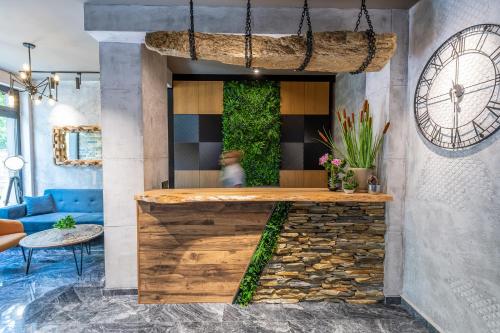 a lobby with a bar with a blue couch at Хотел Камъните in Burgas