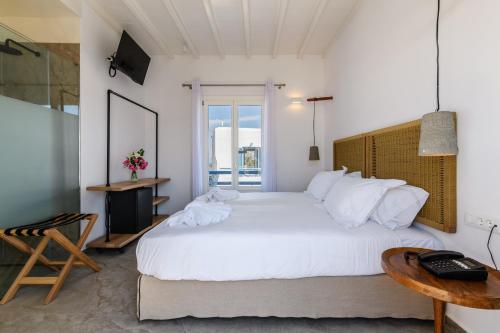 Ένα ή περισσότερα κρεβάτια σε δωμάτιο στο Magas Hotel 