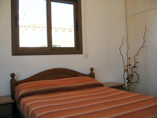 a bed in a bedroom with a window at Paradiso Villa in Protaras