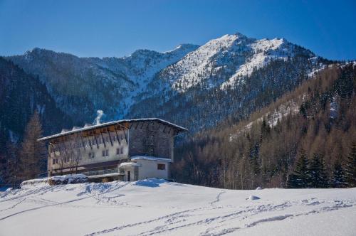a building on top of a snow covered mountain at Hotel Górski Kalatówki in Zakopane