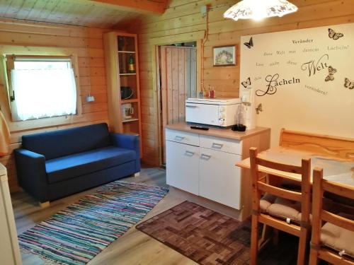 a living room with a blue couch and a table at Ferienhaus im fränkischen Seenland - Altmühltal in Eichstätt