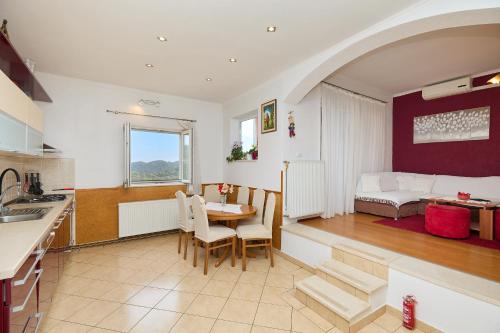 a kitchen and living room with a table and a bed at Agriculture & Holiday house Lasko in Goveđari