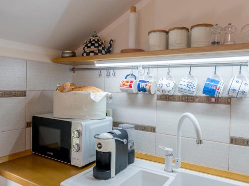 A kitchen or kitchenette at Cicciobello Lux Apartment Baošići with stunning sea view