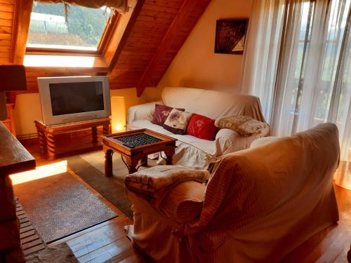 a living room with a couch and a tv at Eth Caneba in Mont