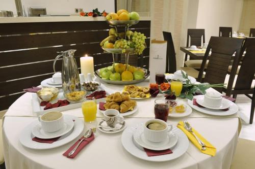 a table with breakfast foods and drinks on it at Europa Hotel in Kastoria