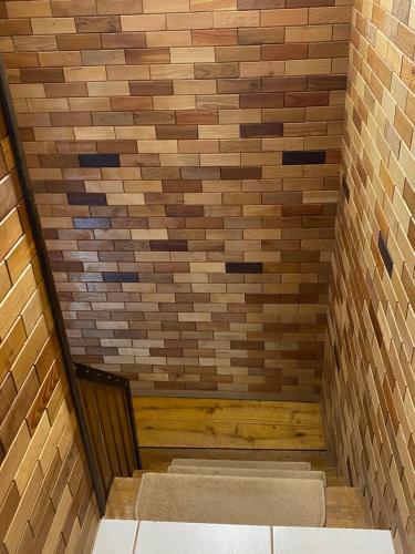 a sauna with a brick wall and a bench at Home Sweet Apartment in Bük