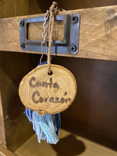 a sign that says camp control hanging from a latch at Hotel Boutique Santo Cuervo in Bernal