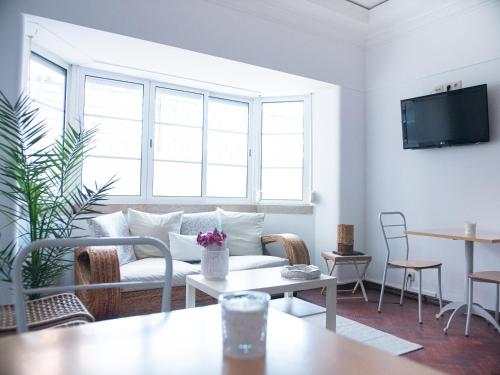 a living room with a couch and a table at Lisbon Top Hostel in Lisbon