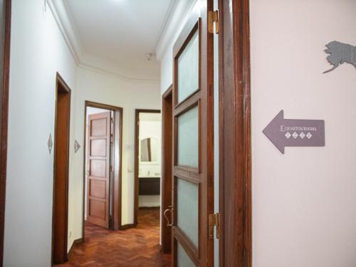 an open door in a hallway with a sign on it at Lisbon Top Hostel in Lisbon