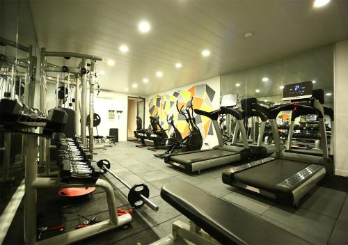 a gym with several tread machines in a room at The Parisian Hotel in Beirut