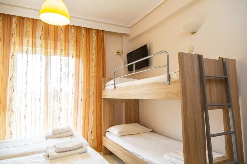 a room with two bunk beds and a window at Sun Studios Pieria in Paralía Skotínis