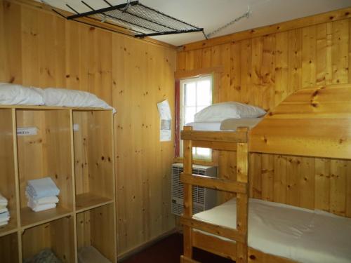 a room with two bunk beds and a window at HI Rampart Creek - Hostel in Saskatchewan River Crossing