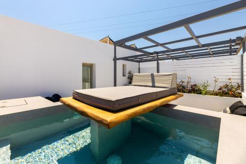 a bedroom with a bed on the edge of a swimming pool at Parion Opus in Naousa
