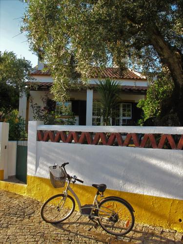a bike parked in front of a white fence at A Casa da Ti Vina in Gavião