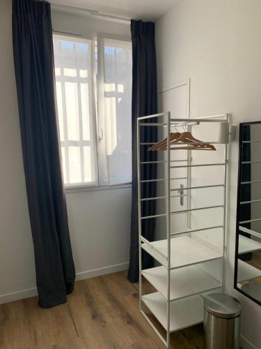 a glass shelf in a room with a window at TY STUDIOS Hyper Centre Ville in Brest