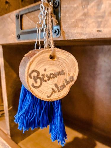 a wooden tag with blue tassels hanging from a drawer at Hotel Boutique Santo Cuervo in Bernal