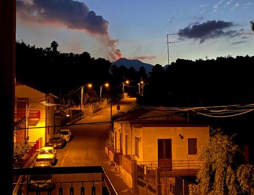 a view of a street at night with cars parked at Dimora di Toosa - Near Taormina in Riposto