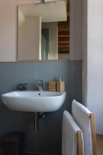 a bathroom with a white sink and a mirror at Cà Piodèe in Faggeto Lario 