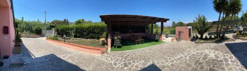 a garden with a pavilion in the middle at B&B Casa Gianfranca in Portoferraio