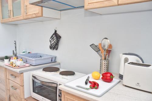 a kitchen with a stove and some vegetables on a counter at Mike's apartments in Agios Gordios