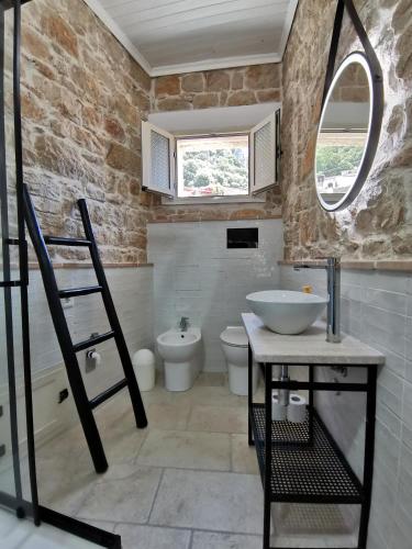 a bathroom with a sink and a toilet at Casa Bellavista in Baunei