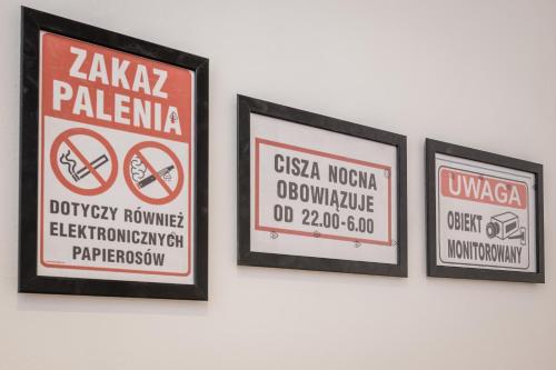 three framed signs hanging on a wall at LoL in Krakow