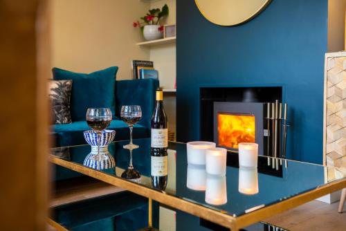 a living room with a blue couch and a fireplace at The Courtyard in Chichester