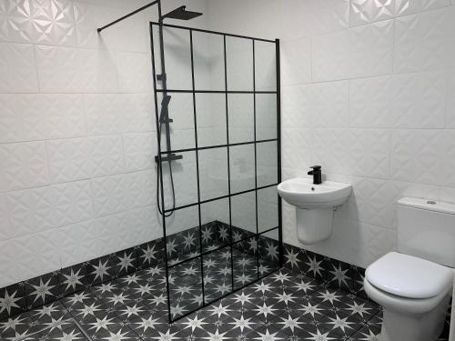 a bathroom with a toilet and a sink at Portaferry Waterfront Townhouse with Hot Tub in Portaferry