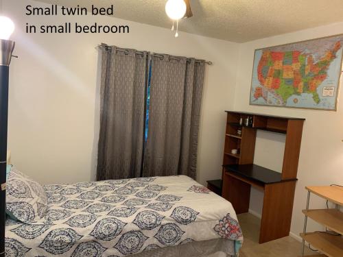 a bedroom with a small twin bed in a small bedroom at House 3br 1-bath, 8-min from Indian Rocks Beach, nice park thru back gate in Largo