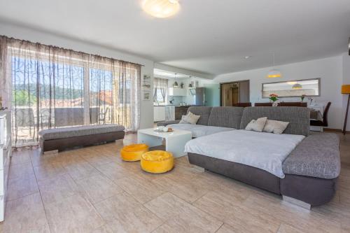 a bedroom with a large bed and a living room at Villa Marta in Grižane