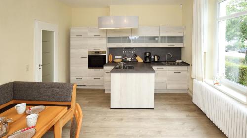 a kitchen with white cabinets and a counter top at Ferienwohnung Am Schildautal-mit Gartenlounge & WLAN in Seesen