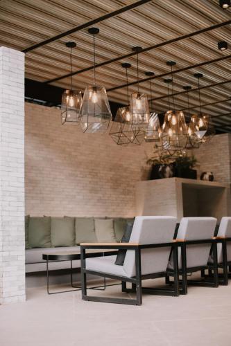 a dining room with a couch and a table and chairs at Rodavento Boutique Hotel & Spa in Valle de Bravo
