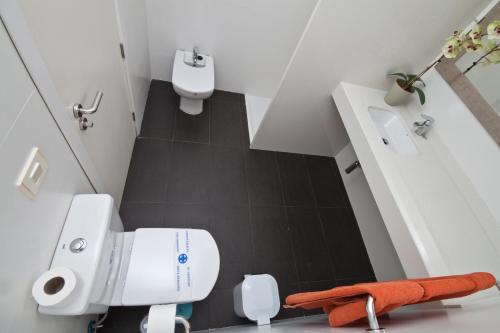 a small bathroom with a toilet and a sink at Amadores Beach Apartments in Mogán