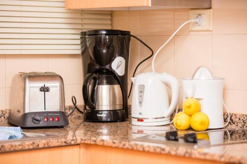 a kitchen counter with a coffee maker and a blender at Amadores Beach Apartments in Mogán