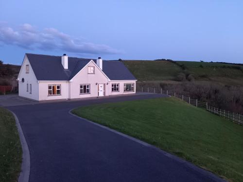 a large white house with a driveway at Sea Crest B&B Rossnowlagh in Rossnowlagh