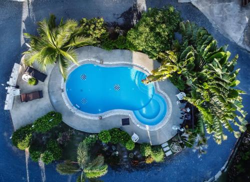 an overhead view of a swimming pool with palm trees at Amy Village Apartments & Digital Hub in Lamai