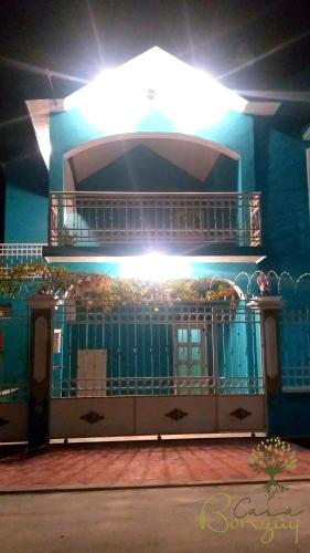 a building with a balcony with food on it at Casa Bonzay in Bacalar