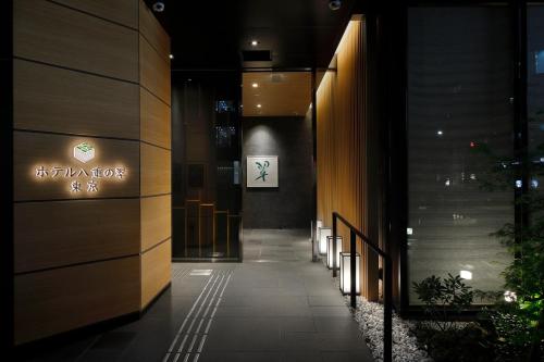 a hallway of a building with a sign on the wall at Hotel Yaenomidori Tokyo in Tokyo